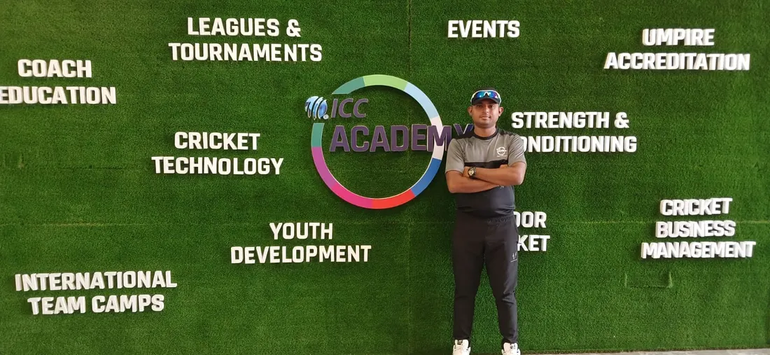 Coach at the ICC Academy Dubai wall featuring coaching pillars including Coach Education, Cricket Technology and Strength & Conditioning