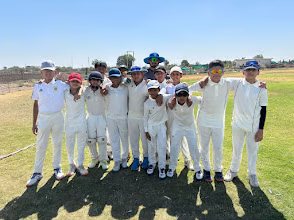 Junior cricketers in whites after a match practice session